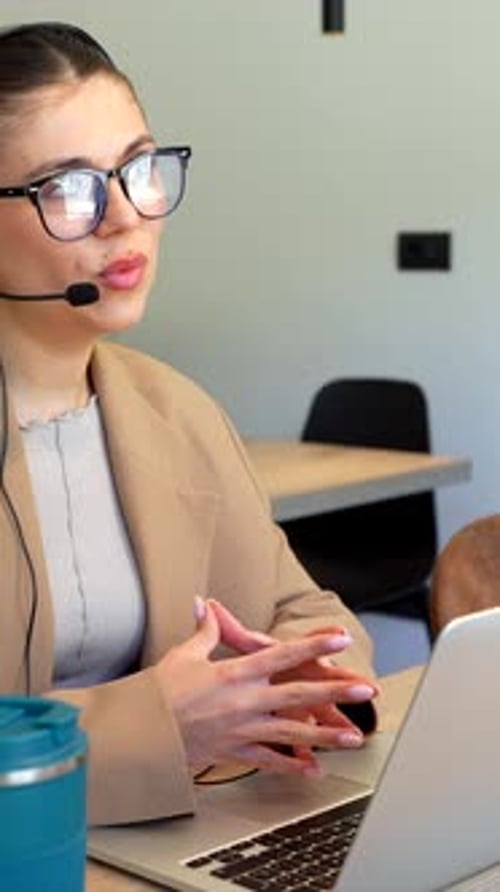Customer service representative talking on headset in office