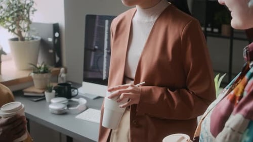 Black Man Chatting with Female Colleagues during Office Coffee Break