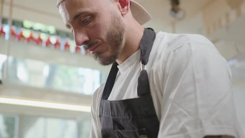 Chef Flattening Pizza Dough by Hand in Pizzeria Kitchen