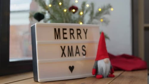 Festive Christmas light box with cheerful message indoors