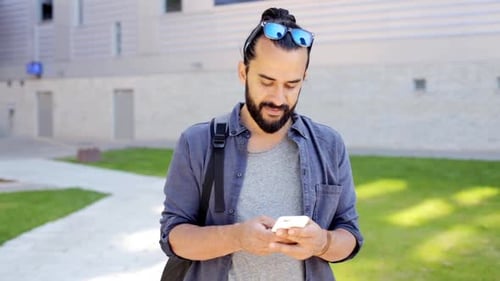 Man Using Phone Outdoors on a Sunny Day