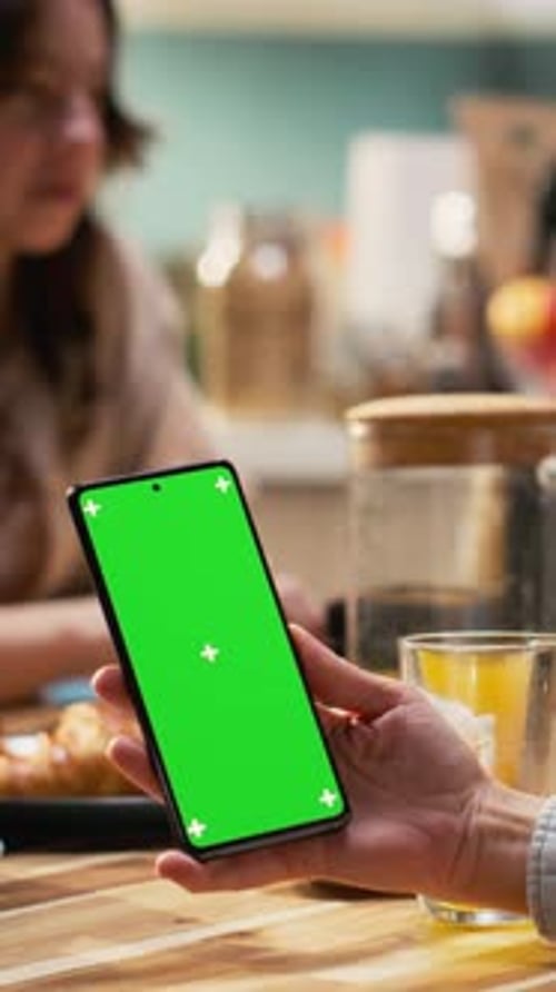 Vertical Video Vertical Green Screen Phone Next to Mother Serving Breakfast with Her Family