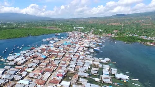 Maumere, 10 June 2015, seafront village with hills in the background