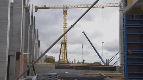 Solid Foundation with Large Yellow Tower Crane and Concrete Structures