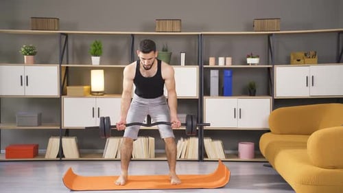 Young Adult Man Weightlifting Barbell at Home