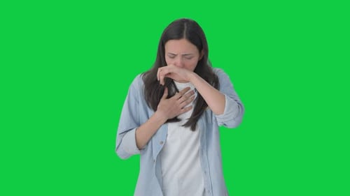 Sick Indian girl suffering from cold and cough Green screen