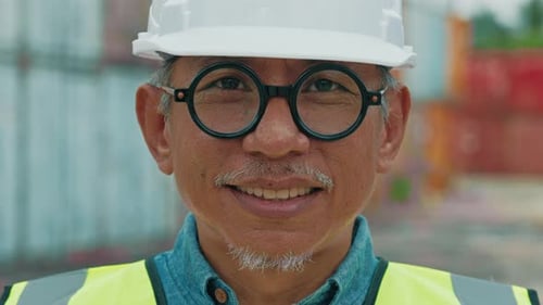 Smiling Construction Worker with Safety Helmet and Vest