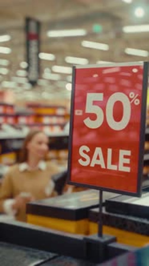 Exciting Discounts Await As Shoppers Explore the 50 Percent Sale in a Bustling Supermarket