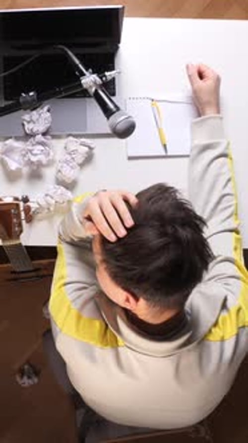 Frustrated man with writer's block at desk
