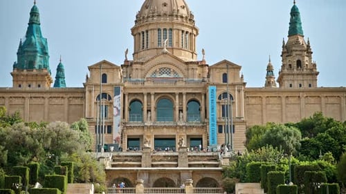 National Art Museum of Catalonia in Barcelona, Spain. Greenery around, people on the cascade stairca