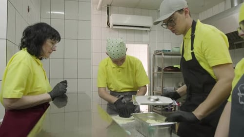 Adults Prepare Food Together in Commercial Kitchen
