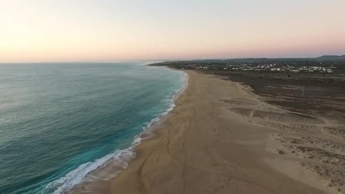 Aerial top view of the Atlantic coast of Spain in Cadiz as the waves meet the beach on a late