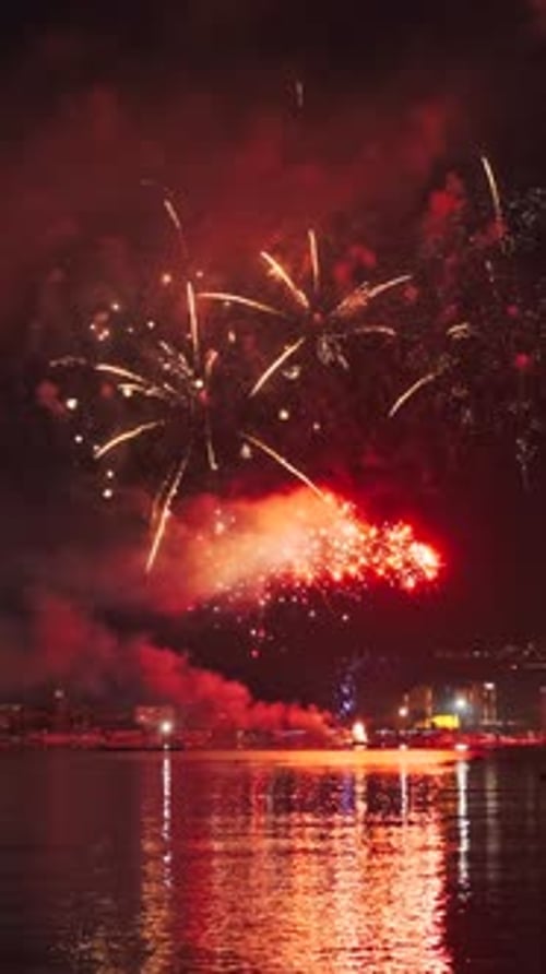 Fireworks with colorful lights over sea