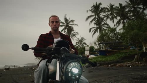 Man Putting Off Motorcycle Helmet Bali Male Motorcyclist Sitting on Motorbike Palm Tree