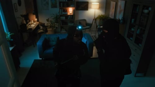Masked People with Flashlights Inside a Home