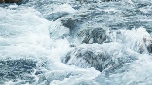 Pure Water Stream Running Through Stone Boulders