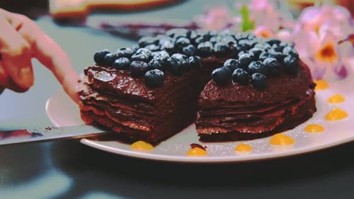 Cutting Slice of Chocolate Pancake Cake with Berries