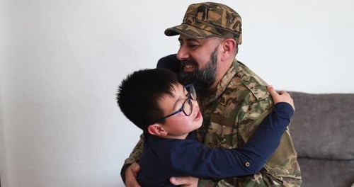 Loving Reunion: Soldier Father Hugs His Young Son