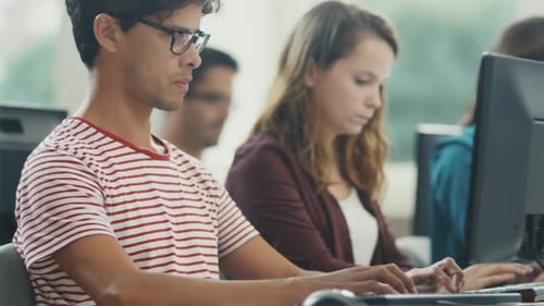 Group of Students are Working on Computers in Classroom.