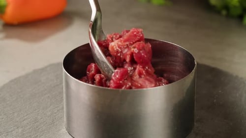 Preparing Diced Meat with Silver Spoon Close Up