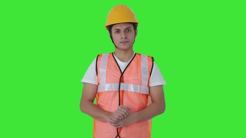 Indian construction labour looking at the camera Green screen