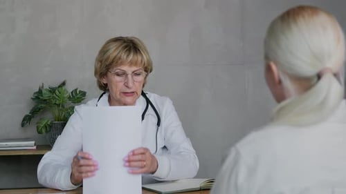 Woman Doctor in Consultation with Patient