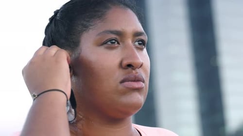 Woman, runner and earphones in city for exercise with streaming, start or listen to music