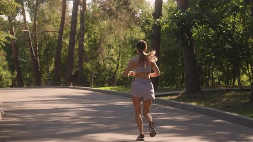 Woman Jogging Through The Park