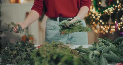 Woman Preparing Christmas Wreath Garland For Christmas Holidays