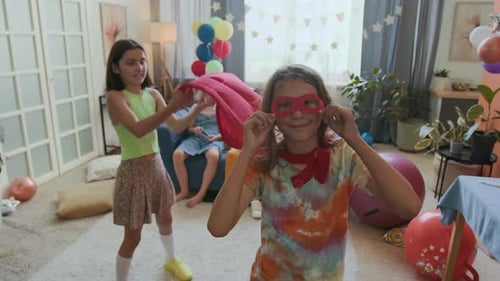 Children in Superhero Costumes Celebrate at Home