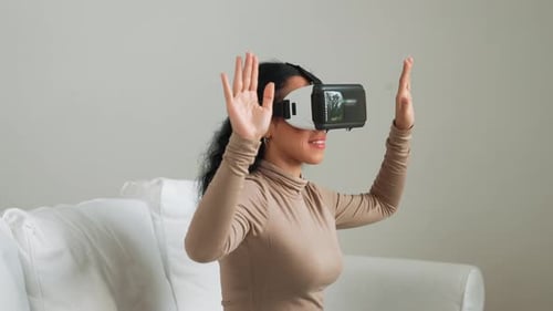 Woman with VR Headset Interacting with Virtual Reality