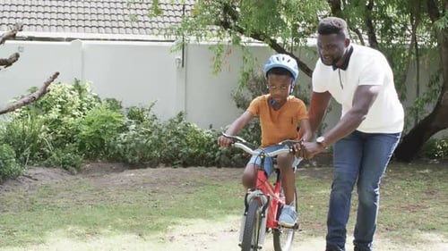 Father Teaching His Son to Ride Bike