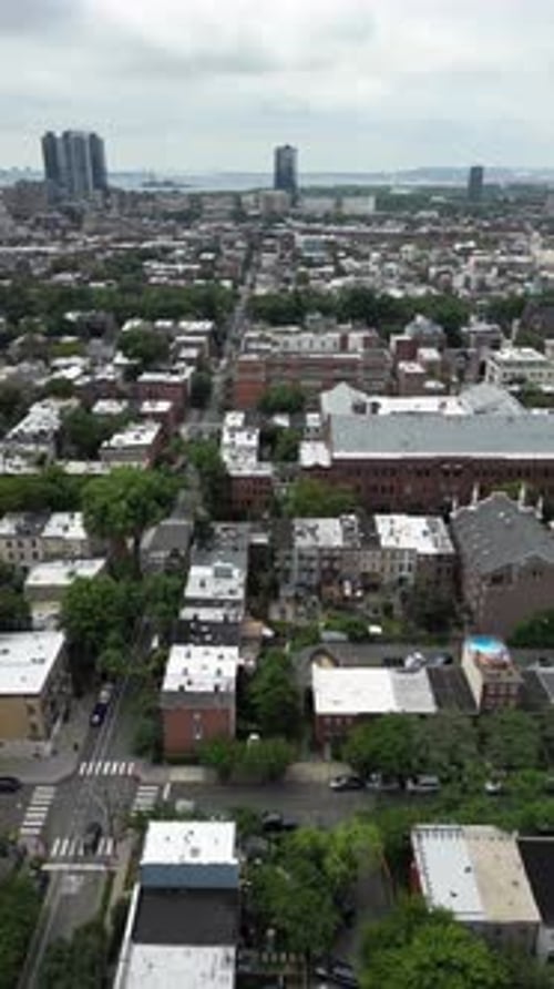 High-angle top-down view of a park in Jersey City featuring symmetrical paths, green spaces, and