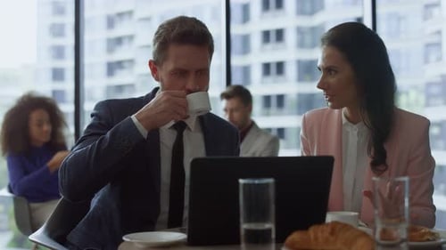 Business Colleagues Working at Cafe on Laptop