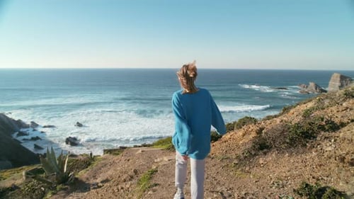 Woman in Blue Sweater Walk on Trail to Ocean