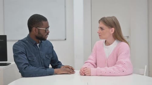 Close up of Middle Aged man Talking Woman in Meeting