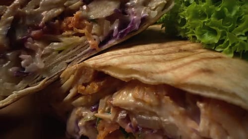 Tasty Doner Kebab Close Up on Wooden Background Tortilla Wrap with Fried Chicken Meat and Vegetables