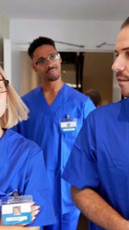 Multiracial team of doctors and nurses walking through a hospital corridor