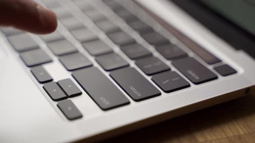 Closeup of Finger Pressing Enter Key on Modern Laptop Keyboard Man Pushes Enter Button on Notebook