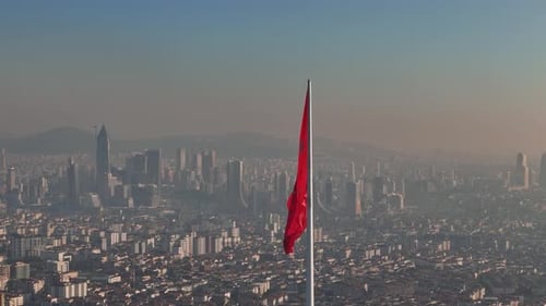Aerial View of City with Prominent Red Flag
