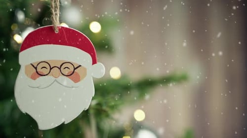 Festive Santa Ornament on Christmas Tree with Snow