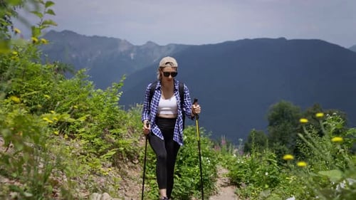 A Young Athletic Woman Goes Hiking in the Mountains Summer Season of Mountain Climbing and Trekking