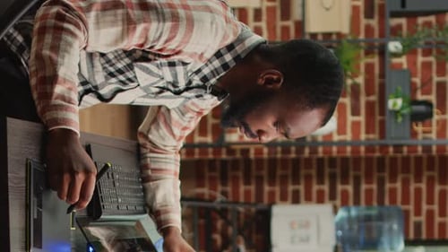 Man Working at a Standing Desk with Stylus