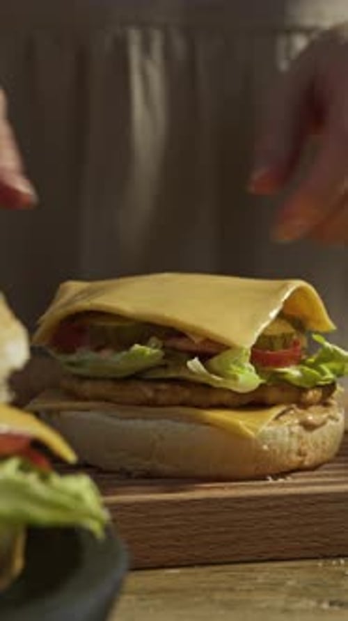 Woman Cooks Cheeseburger She Puts Cheese on Slices of Pickles Then She Covers It All with Sesame