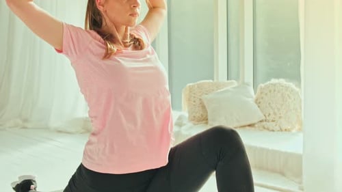 Woman Doing Yoga Stretches on Mat at Home