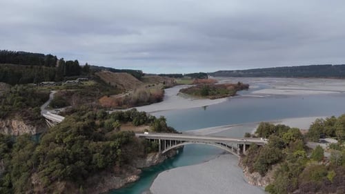 Automobile Bridge Crosses River with Water Frozen Near Banks