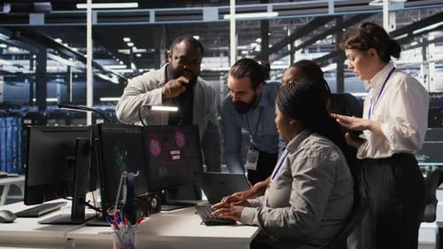 Team Collaborating on Technology Problem in Modern Office