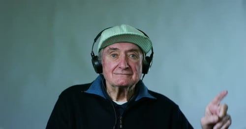 Senior Man Listens and Raises Finger