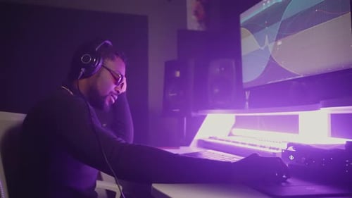 Black Man Musician is Listening to New Song in Professional Recording Studio Sound Designer