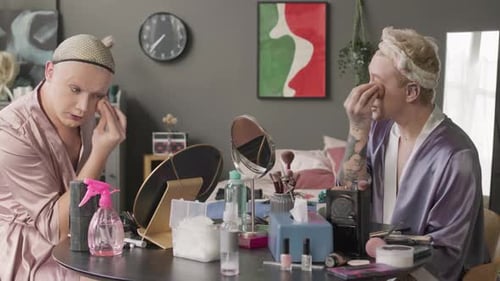 Queer Men Applying Face Foundation with Sponge at Home